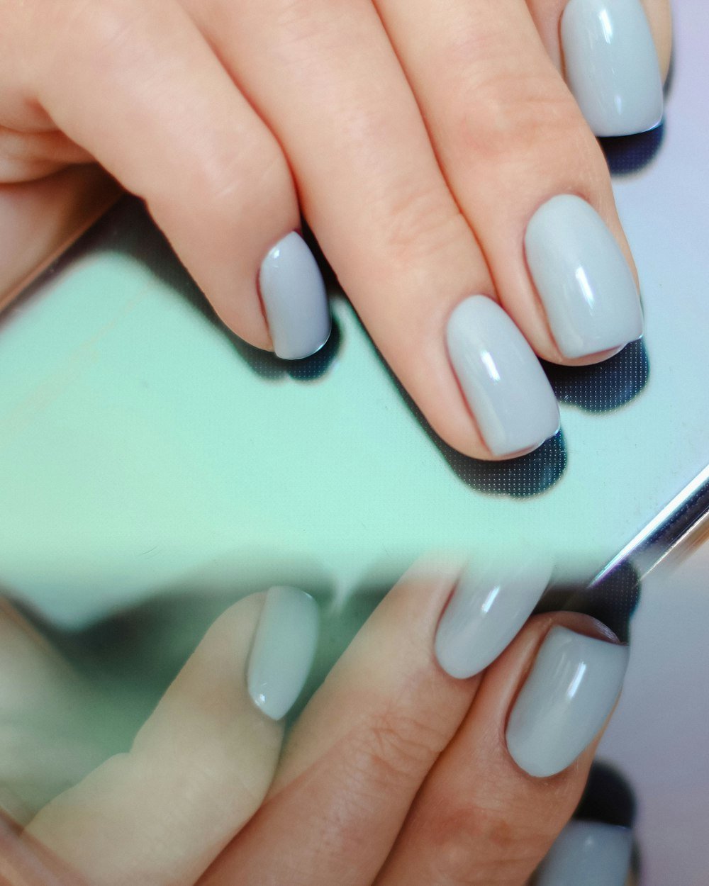 Hand with pale neutral nails