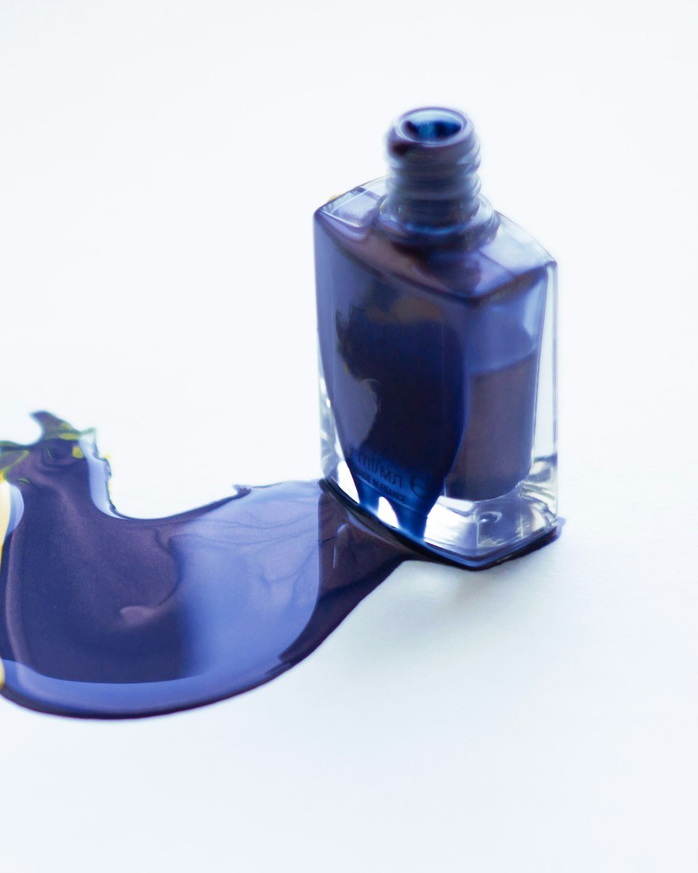 Nail polish bottles grouped on a pale surface